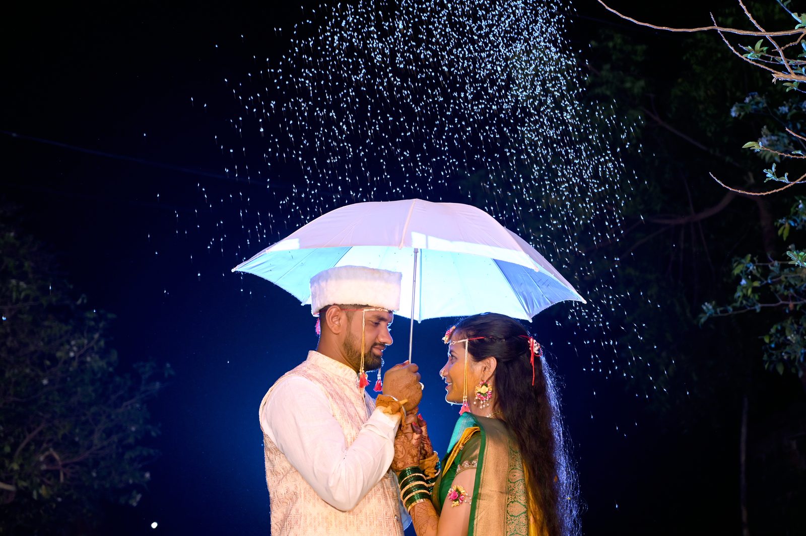 Couple under umbrella at haldi
